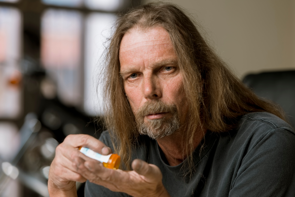 man with opioid bottle